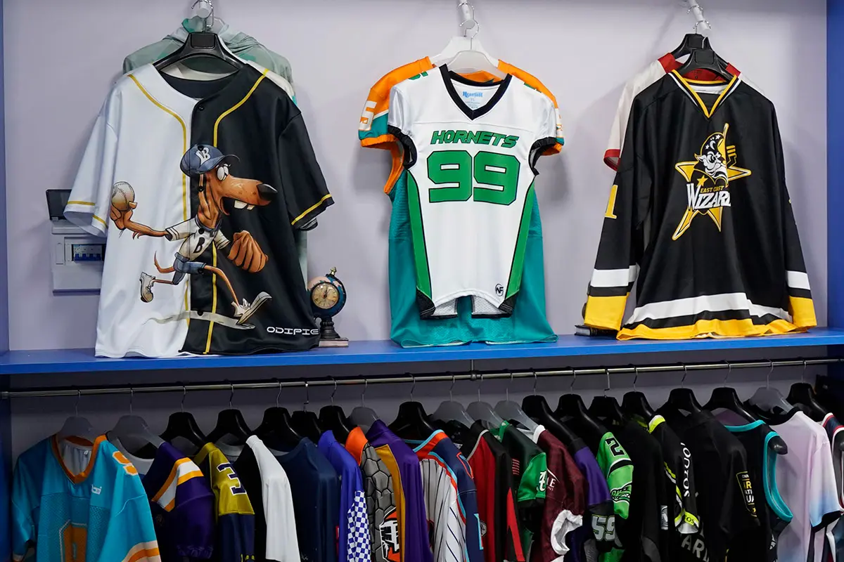 Baseball, American football, and hockey jersey samples on display
