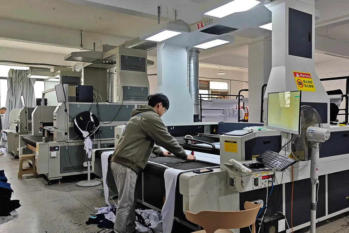 Operator preparing jersey fabric on a digital cutting table