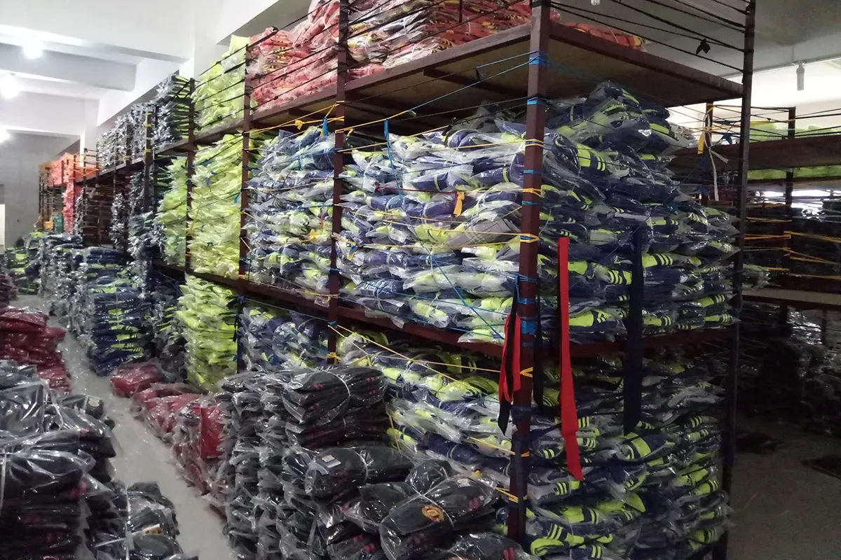 Packed high-visibility jerseys grouped on warehouse racks