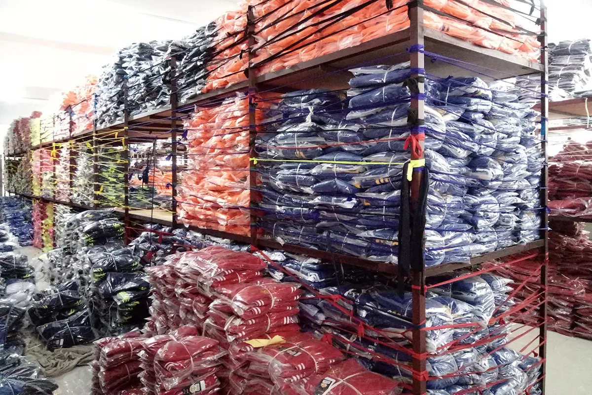 Packed jerseys grouped by color on warehouse racks