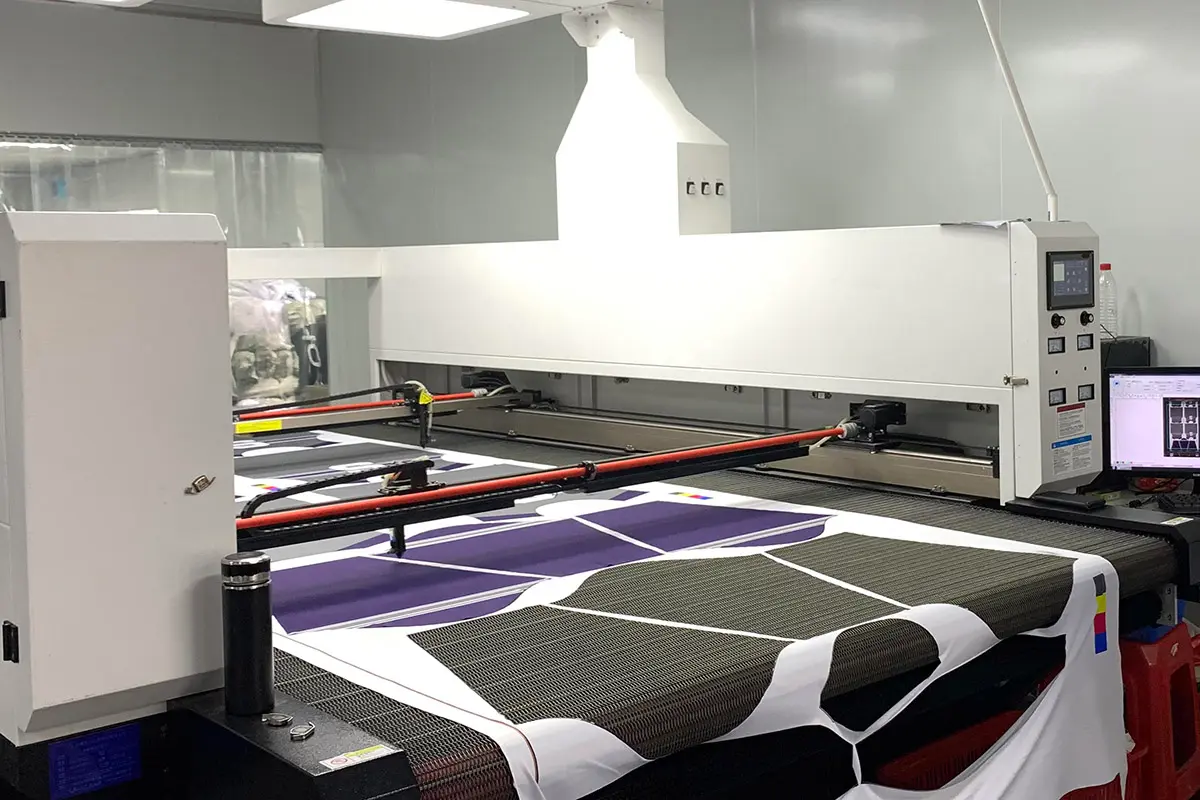 Printed jersey panels moving across an automated cutting table