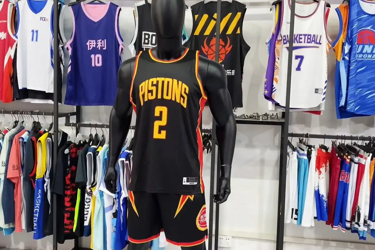 Basketball jerseys and shorts displayed around a mannequin