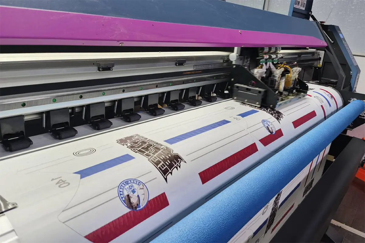 Player number and team artwork moving through a wide-format printer