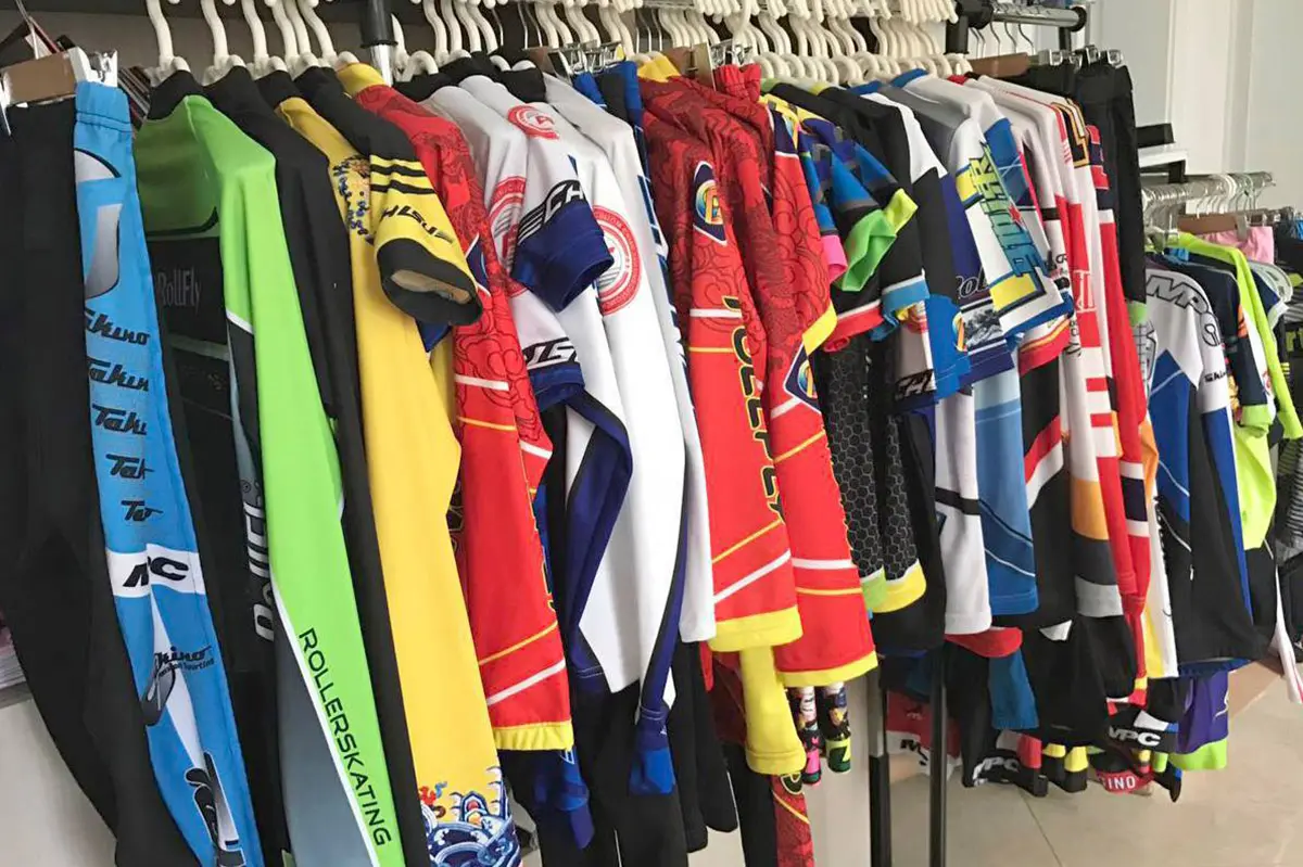 Hockey jerseys hanging with other custom samples in the sample room