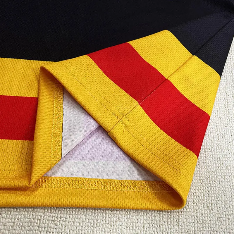 Close-up of red and yellow hockey jersey stripes and seam finishing