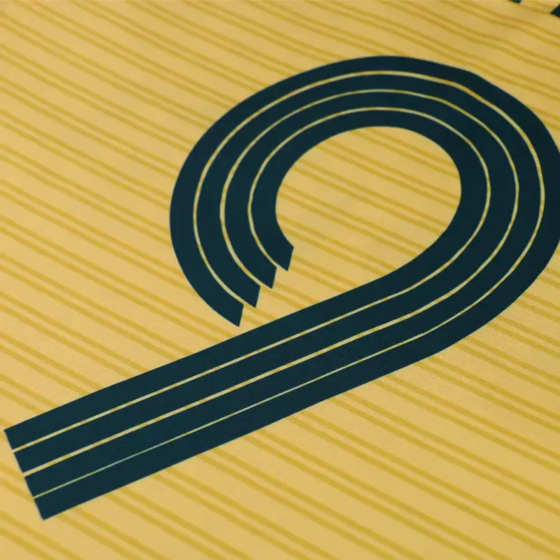 Close-up of navy number 9 printed on a yellow soccer jersey
