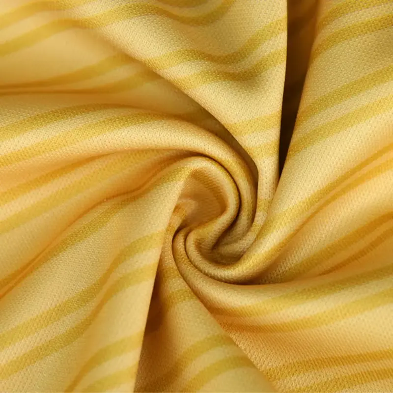 Close-up of yellow patterned polyester soccer jersey fabric