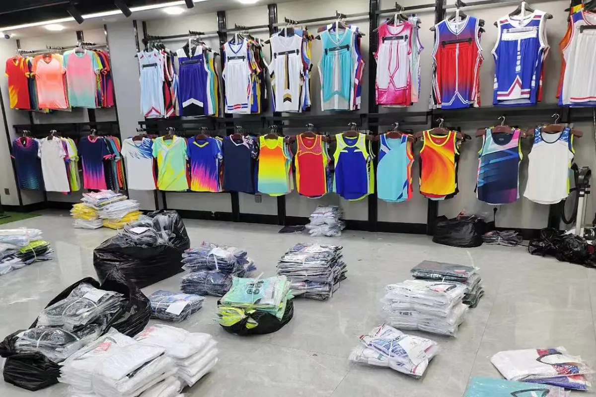 Hanging jerseys displayed above folded teamwear