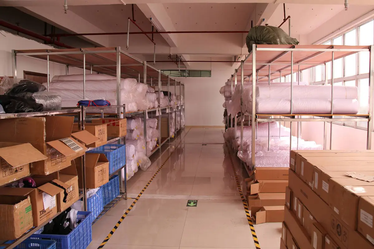 Fabric rolls and cardboard cartons stored in the material room