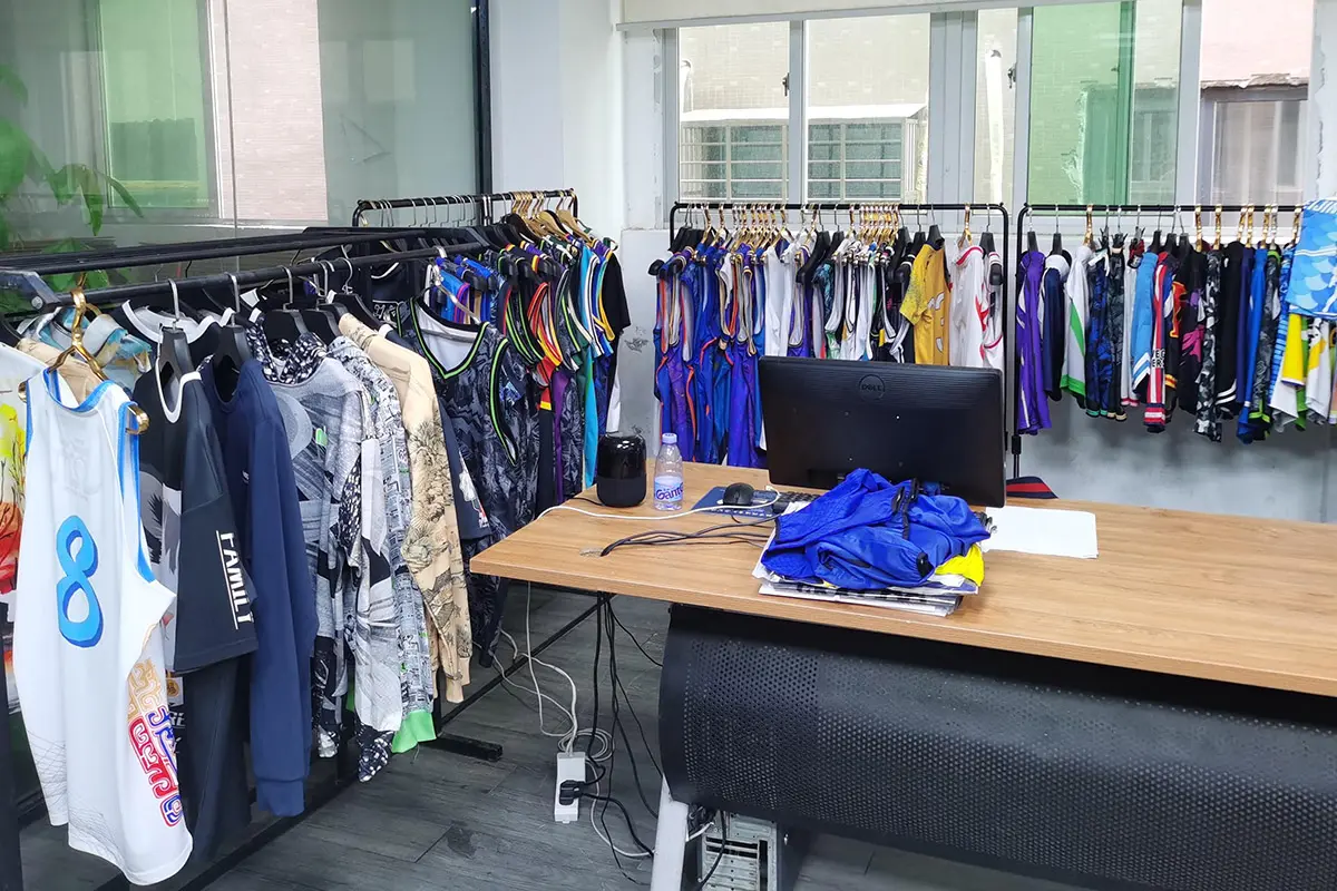 Numbered team jerseys arranged in the sample room for size reference