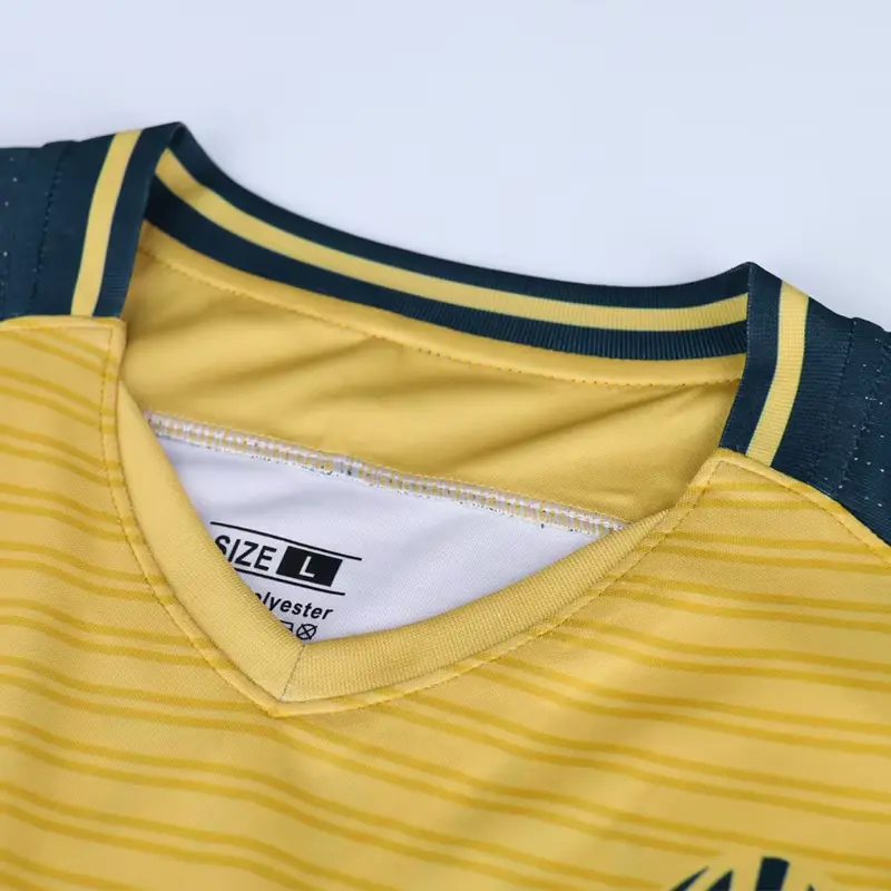 Close-up of navy and yellow binding on a soccer jersey neckline