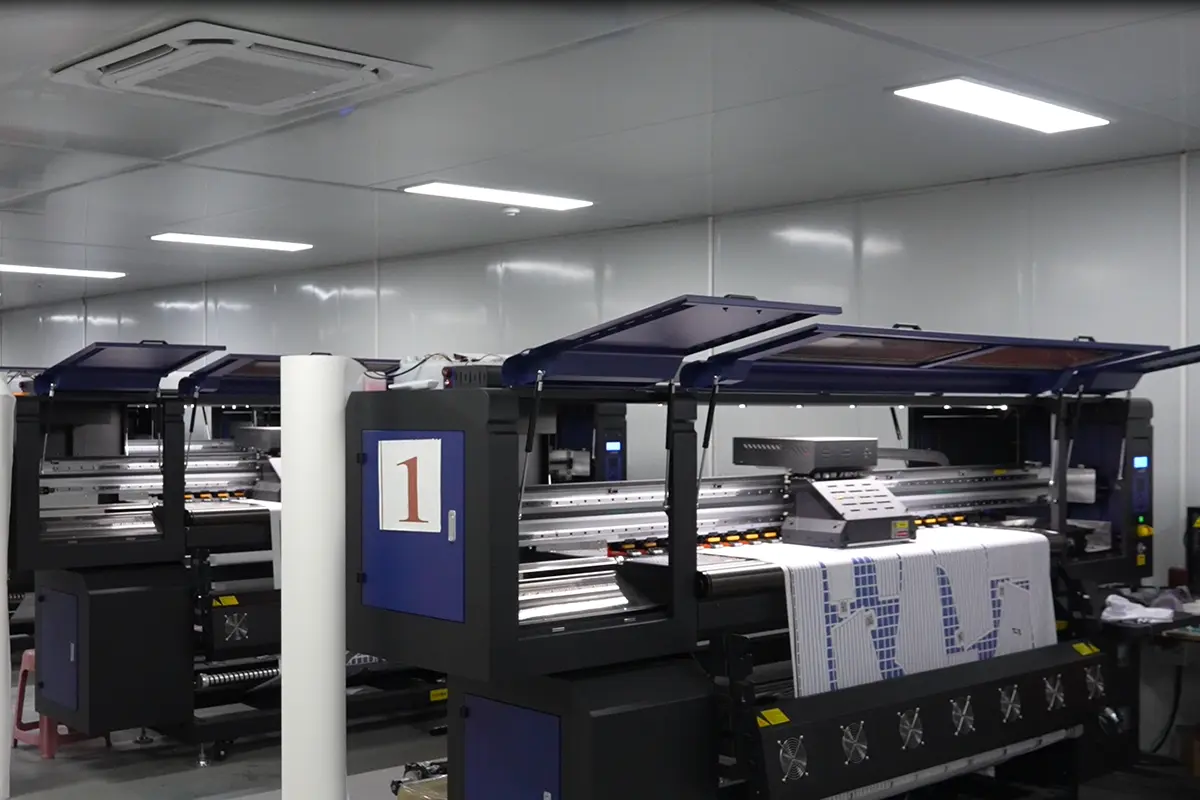 Wide-format printer producing a blue and white jersey panel