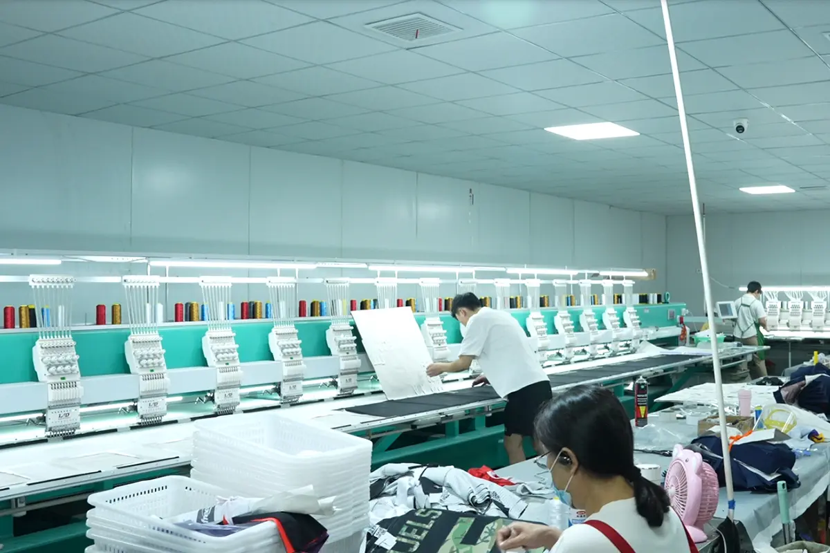 Operators working beside multihead embroidery machines