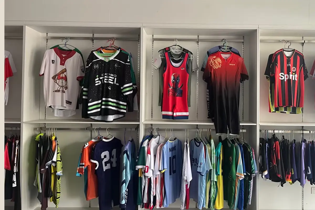 Mixed sport jersey samples displayed across showroom racks