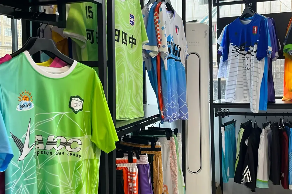 Soccer jerseys and shorts in different colors displayed in the sample room