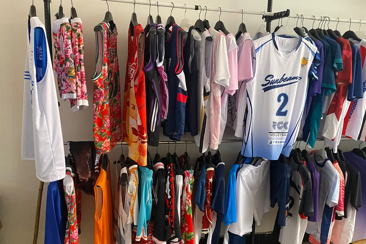 Volleyball, basketball, and other jersey samples arranged on showroom racks